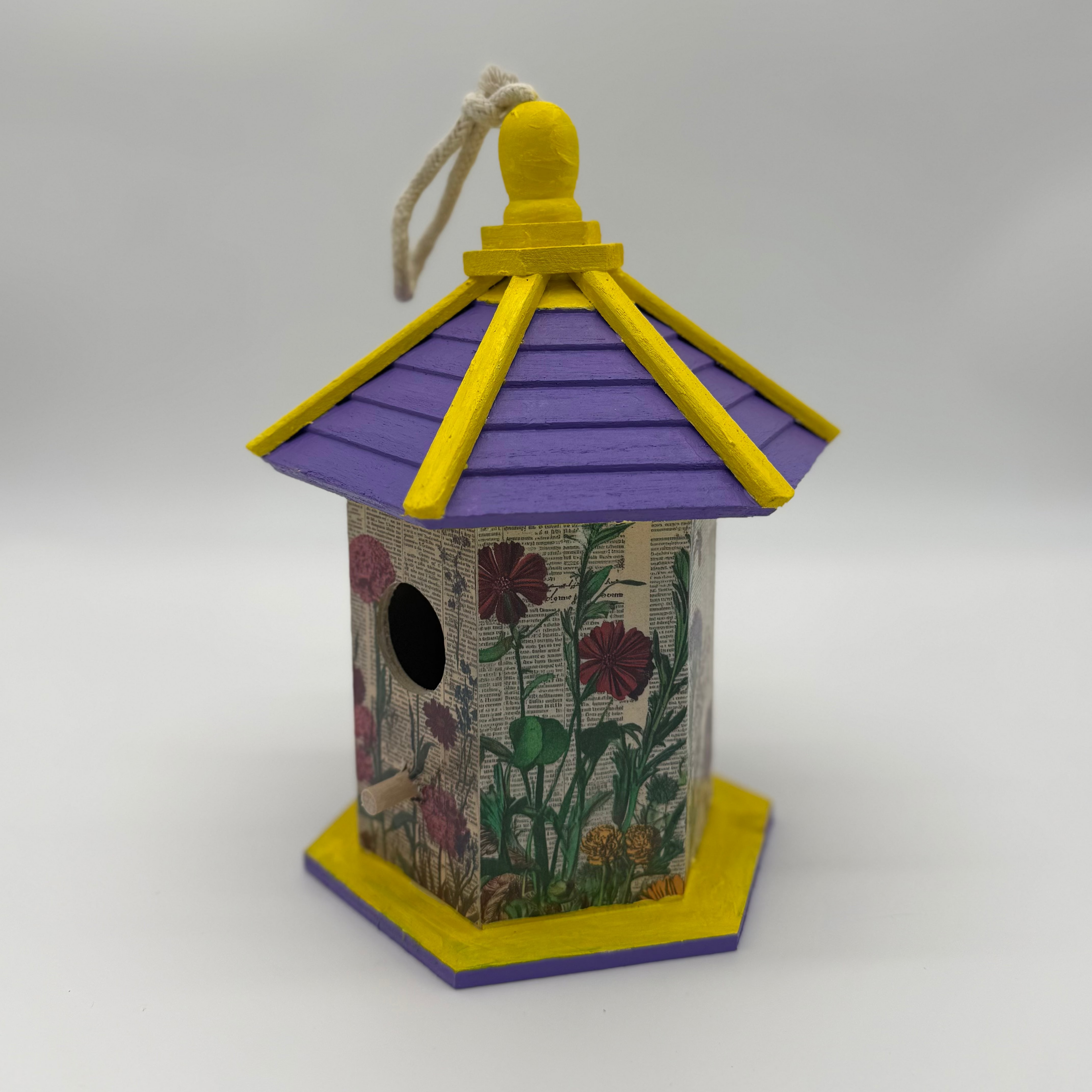 Decorative birdhouse with floral patterns on a white background