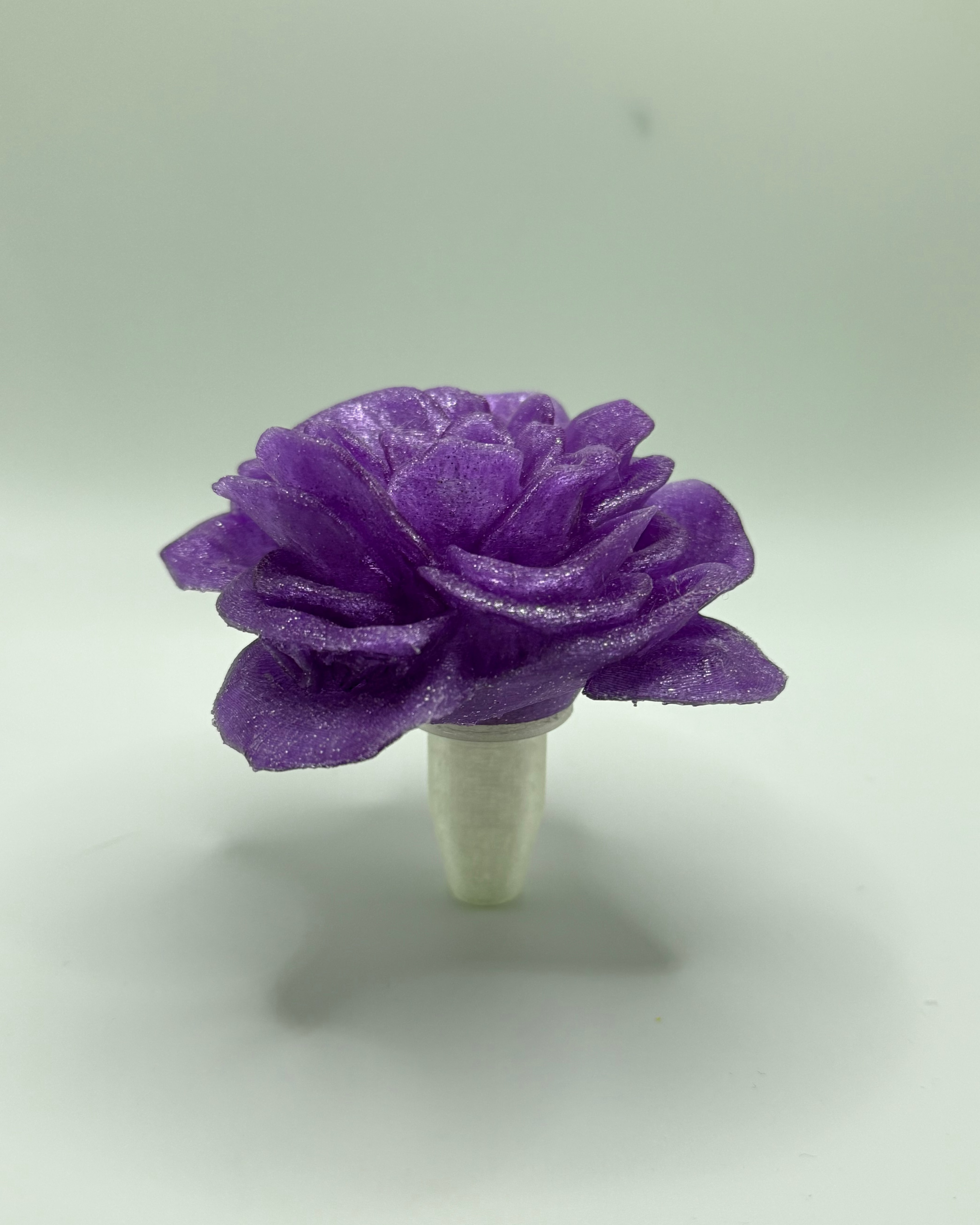 Purple flower-shaped stopper on a white background