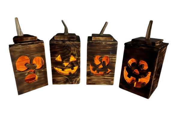 Four dark stained wooden lantern boxes with carved jack-o'-lantern faces, each with a small wooden spoon resting inside, shown against a plain white background.
