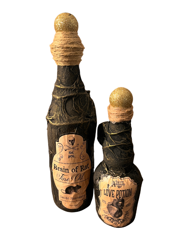 Two decorative Halloween potion bottles on a white background. The larger bottle is labeled 'Brain of Rat Fine Oil' and the smaller bottle is labeled 'Love Potion'.
