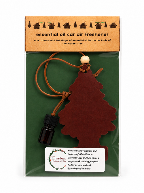 Essential oil car air freshener with tree design on a green background
