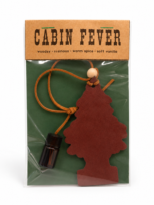 Cabin Fever air freshener packaging with a tree-shaped car air freshener and small bottle on a white background.