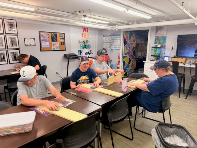 Group of people working on a project in an art studio setting