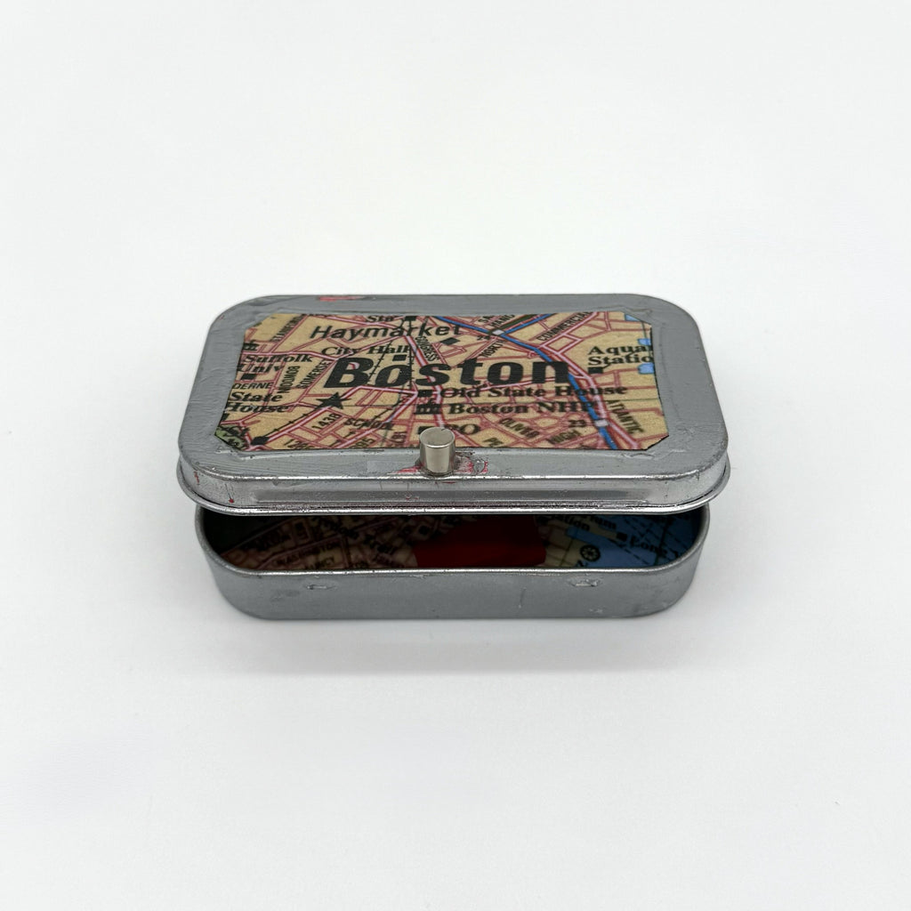 Tin box with a map design on the lid on a white background