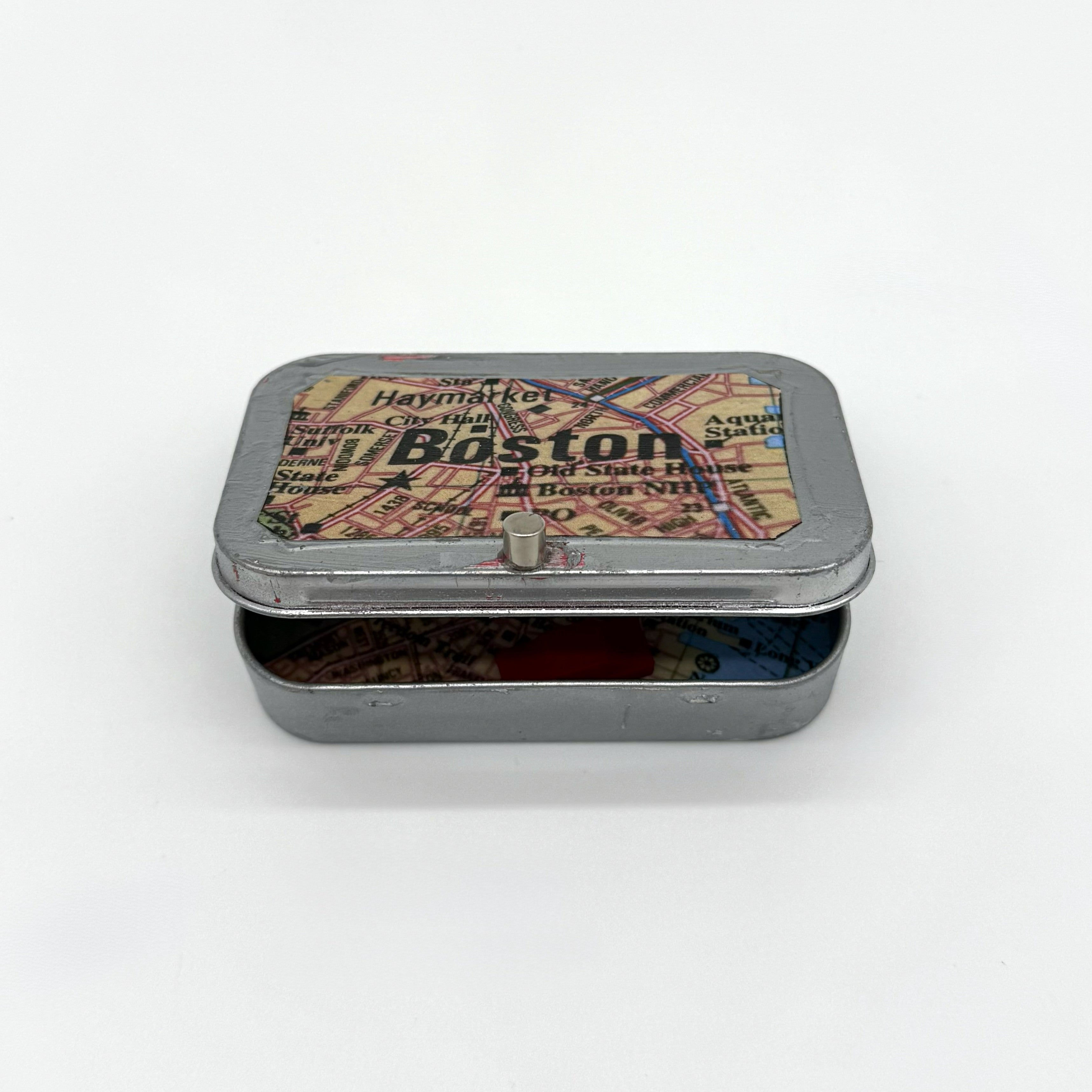 Tin box with a map design on the lid on a white background