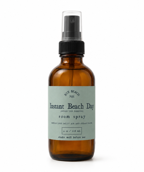 Brown spray bottle with green label that reads" instant beach day"