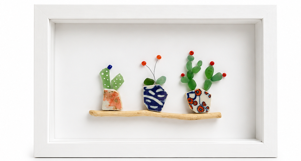 Decorative wall art with seaglass pots and plants on a white background